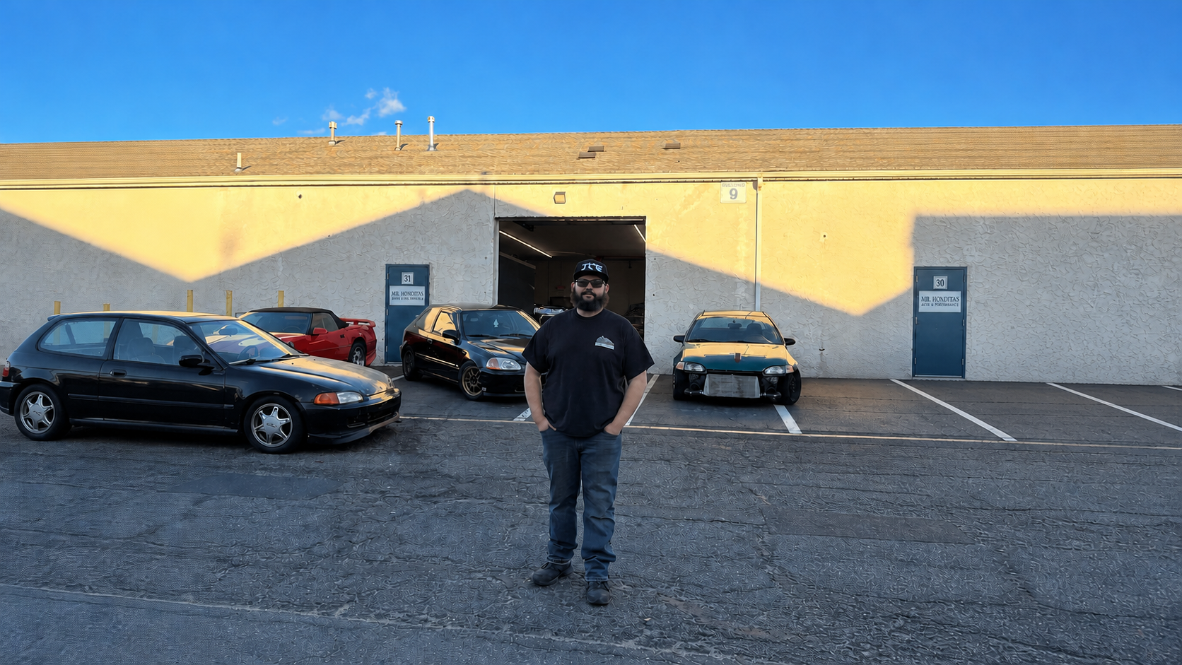 David, founder of Mr. Honditas, standing in front of the Toms River, NJ shop and customer cars