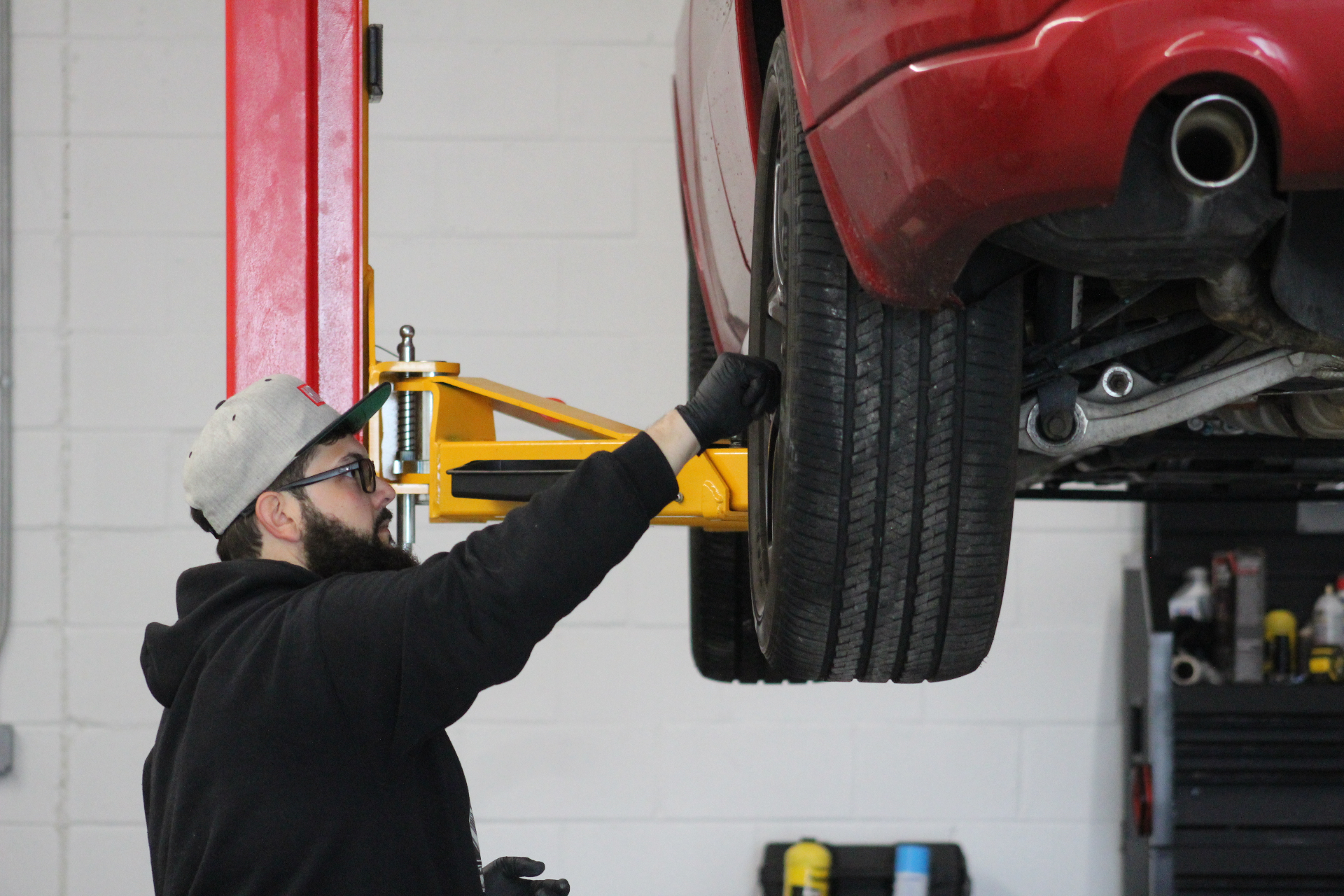 David servicing a raised vehicle inside the Mr. Honditas shop in Toms River, NJ