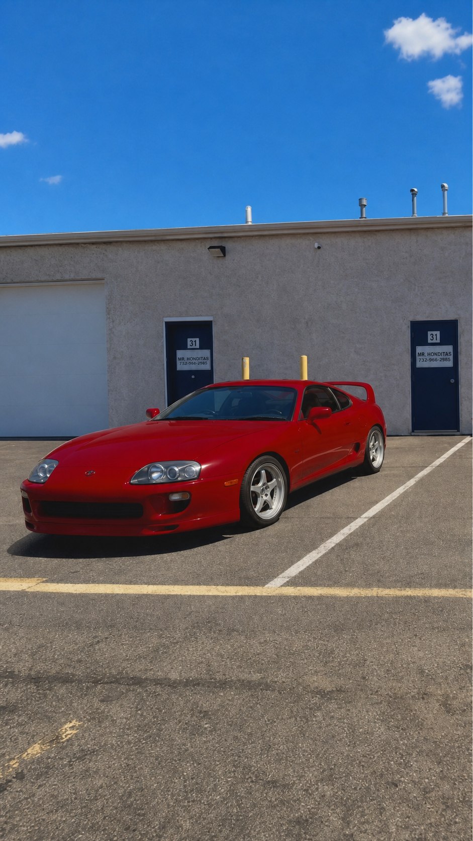 Red Toyota Supra with exterior performance styling outside the Mr. Honditas shop