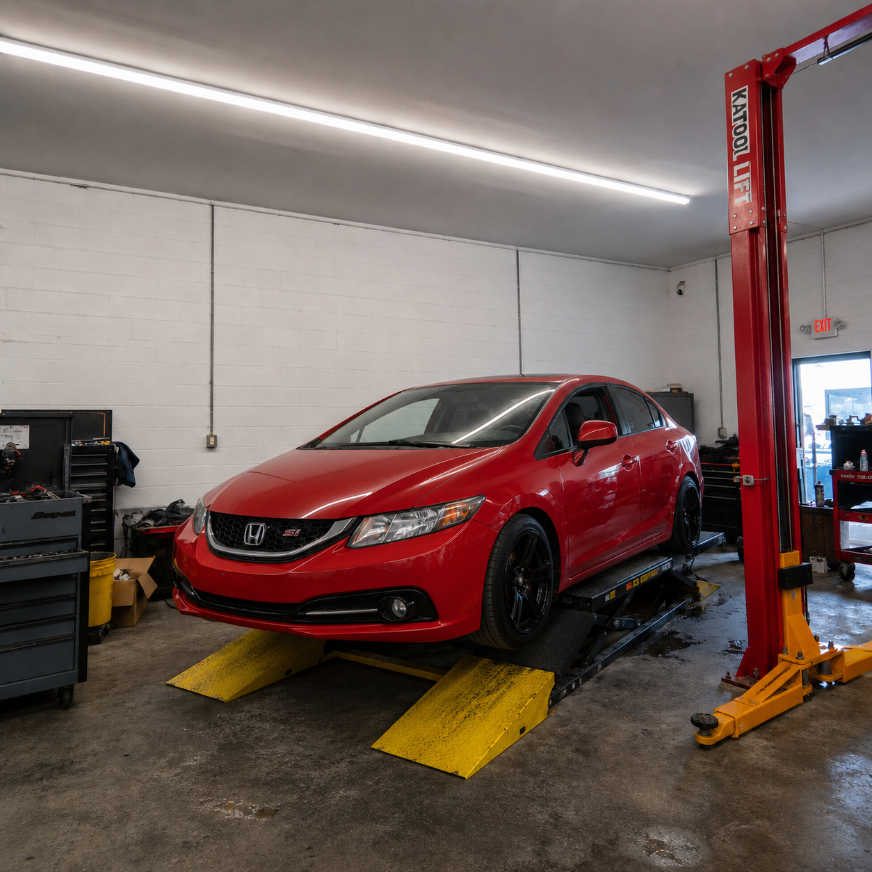 Red Honda Civic Si on a lift at Mr. Honditas in Toms River, NJ