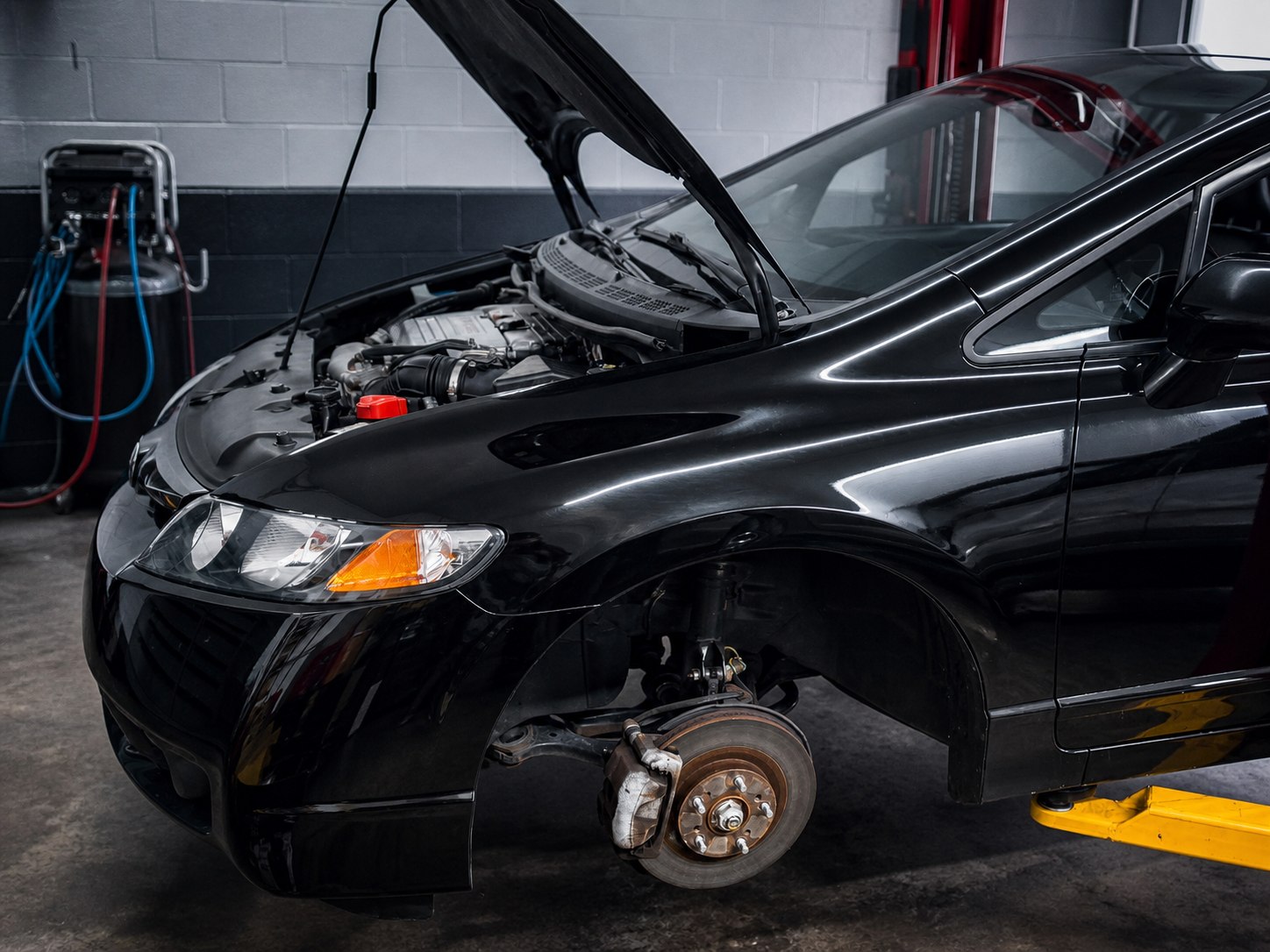 Black Honda with its hood open for diagnostics at Mr. Honditas in Toms River, NJ