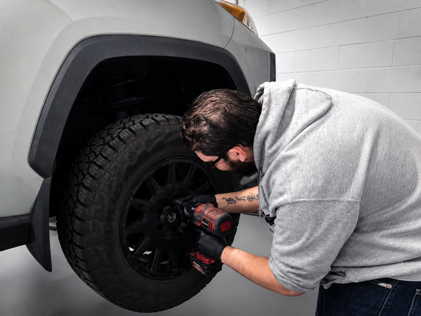 Technician installing a truck tire at Mr. Honditas Auto & Performance in Toms River, NJ