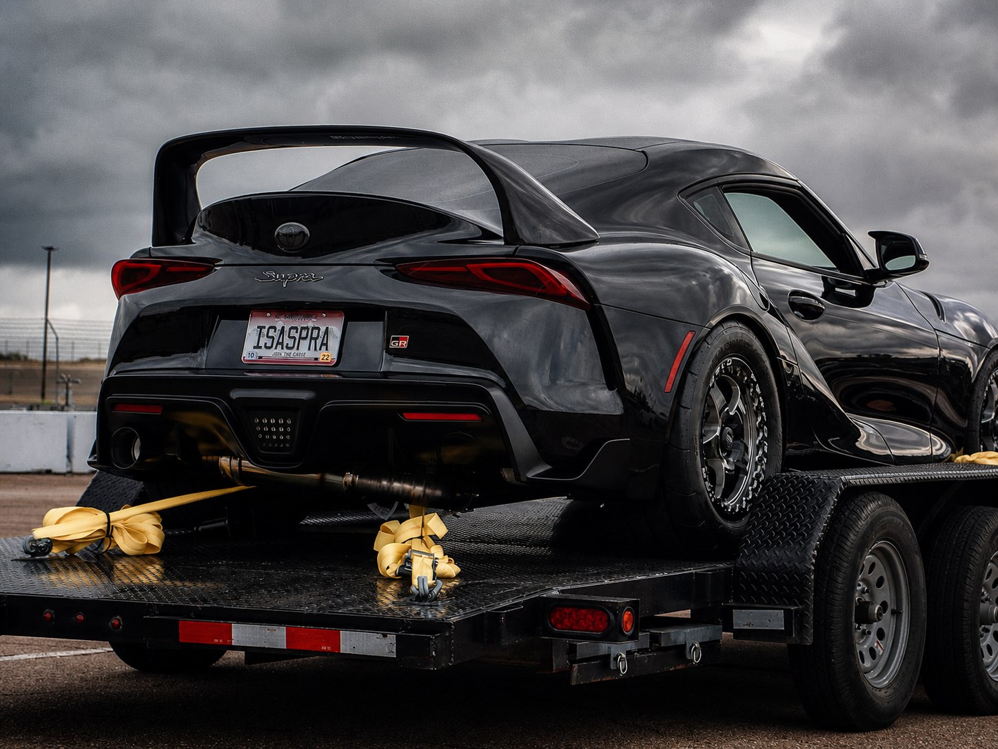 Black Toyota Supra secured to a flatbed for towing by Mr. Honditas in Toms River, NJ